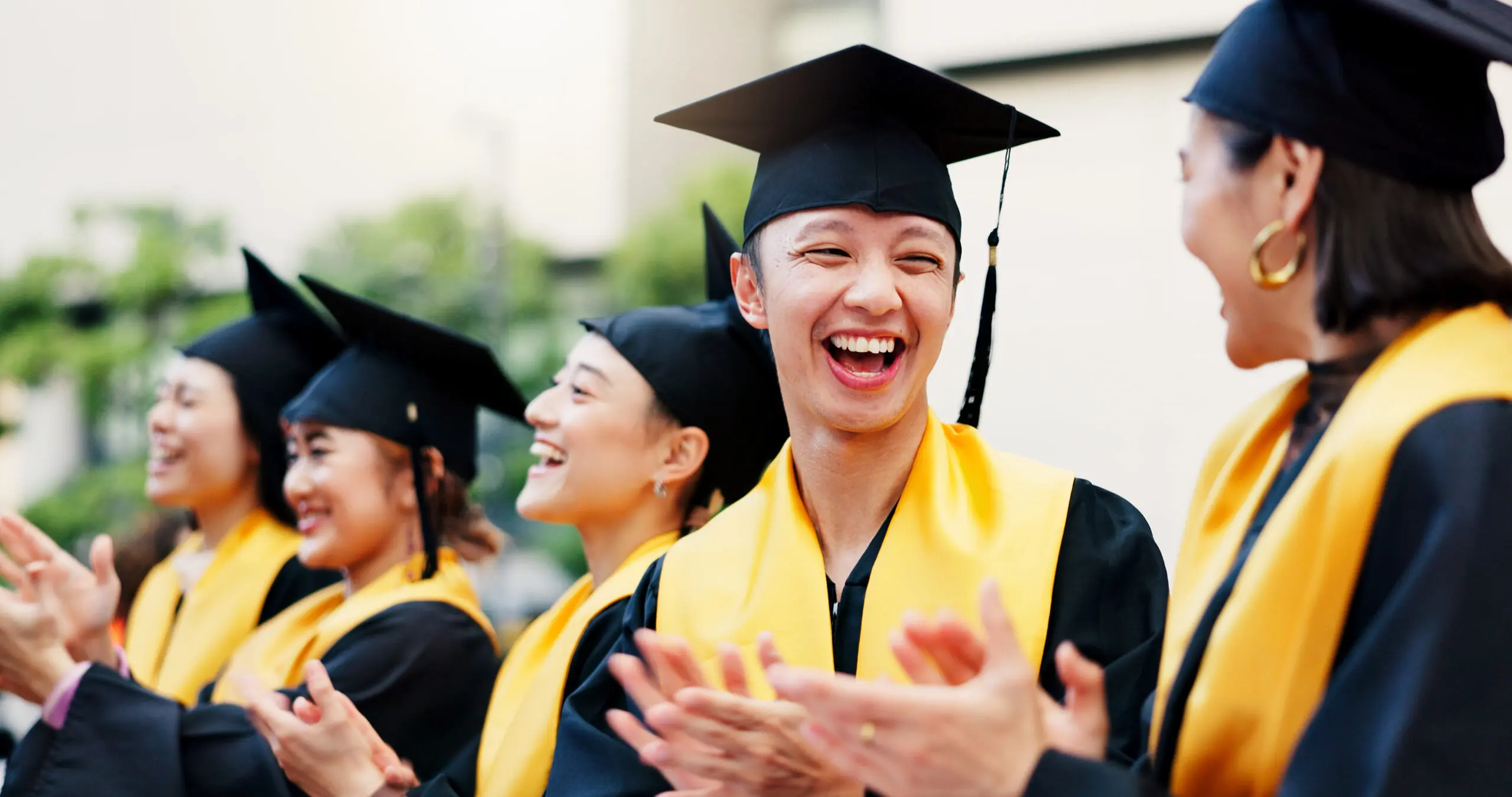 Cheering, graduation and group of students, education and excited for success, happy and achievement. College, accomplishment and applause for knowledge, friends and Asian people on event in Japan